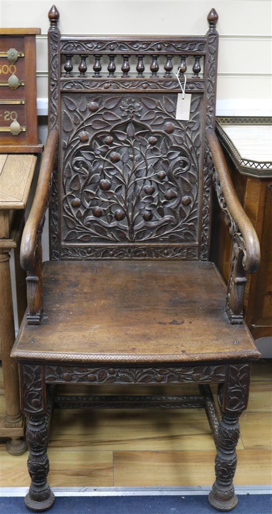 A pair of foliate carved armchairs